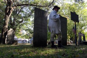 Village Historian Paul Loding talks to visitors at a presentation in Baker Cemetery.